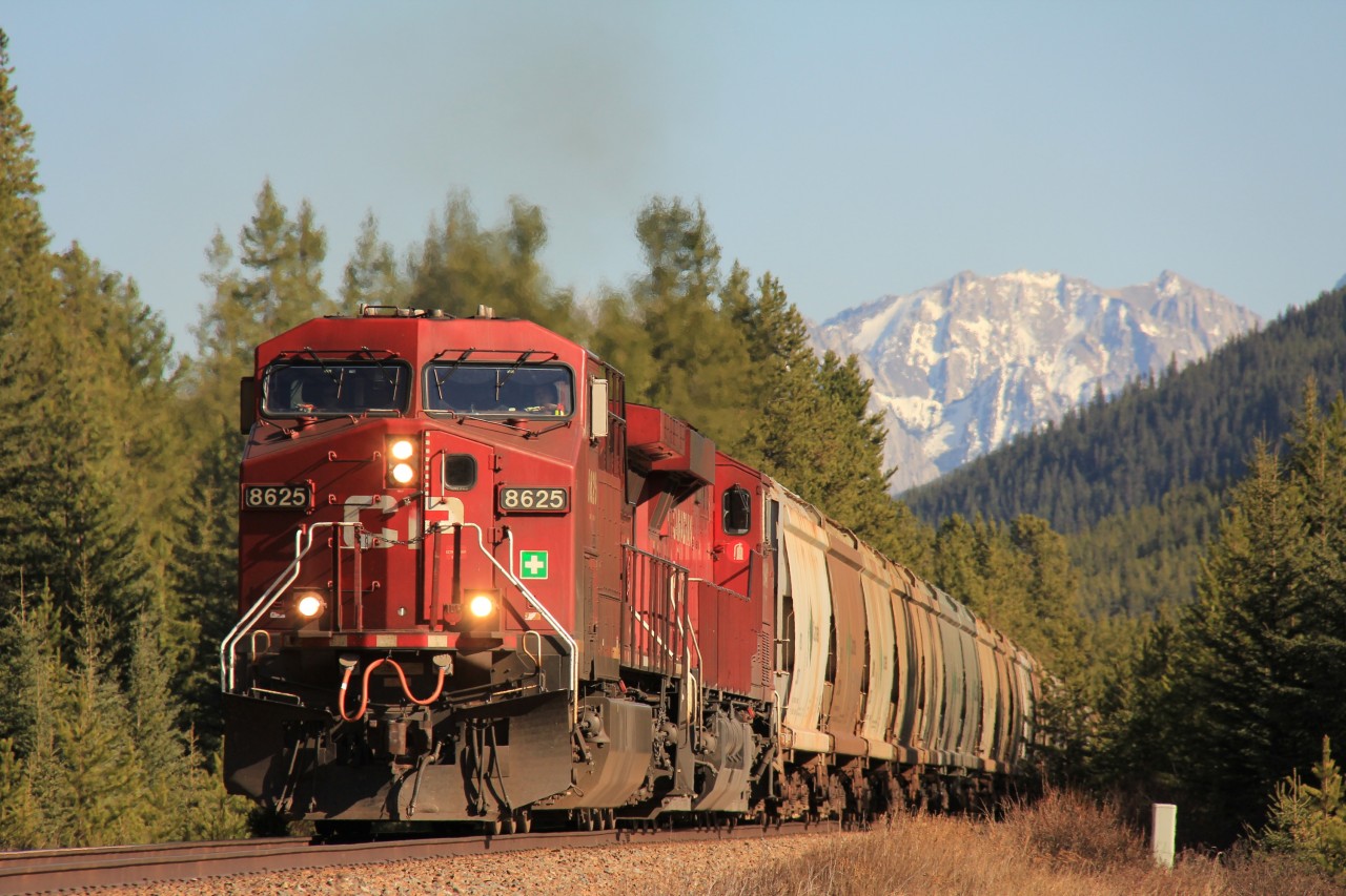 A westbound unit potash train charges into the setting spring sun. While waiting for this train to arrive a motorist at the nearby crossing was kind enough to warn of us of bears that had been spotted in the area coming down from the mountains and to be vigilant!