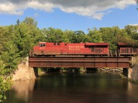 CP 8771 north rolls over one of the three bridges in town that carry the railway over Bala Bay and the famous falls at highest point and start of the Moon River. 