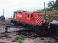 Hated starting off saying "This is the Pits" but just couldn't help it. There is a really good story behind this unfortunate incident, but since the person responsible is still working for a railroad, and is in Ontario; I would much rather leave it for him to write and comment on it, rather than attempt to go into detail and mess it up. What I did hear, when one day I met a guy who asked me if I was the one who posted a previous photo on RP regarding this incident, was that back then the one involved had just arrived in Alberta (from Ontario) with a friend, looking for work. He was hired on here at The Hat doing odd jobs in the yard. No sooner than he had gotten the feel of the place, an impatient hogger told him to "move the unit". He said he did not know how, but was talked into trying. And this was the result. It can't be seen in this photo, but the fuel tank was ruptured and it was really pouring out when I went over to have a look at things. Those were the days when a stranger with a camera could wander at will. Hard to believe. I'd love to hear from the unfortunate "potential engineer" if he is still checking photos on this site.  You were what, 19 years old back then? All is forgiven. :o)