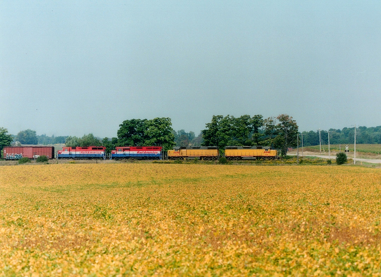 Moving along eastward at track speed, GEXR's morning 432 is about to cross over the Woolwich-Guelph Townline Rd approaching what used to be known as Mosborough Station. Interestingly enough, this train would have the same lead unit number upon return from its' Stratford to CN Mac Yd run, due to the fact the LLPX 2210 leader has RLK 2210 trailing! Between are LLPX 2236 and RLK 4096. The RLK 2210 was later changed to 2211.