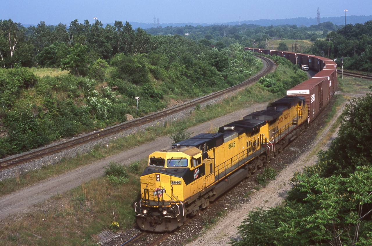 CNW 8646 and UP 9621 lead NS 328 through CN's Hamilton West on a sunny June 30th 2005. A big thanks goes out to RP.ca contributor Marcus Stevens for taking a teenage yours truly trackside that day. 327/328 photos always seem to generate some good memories when posted here. I can say for sure that this was the juiciest 328 lash up I ever got on film.