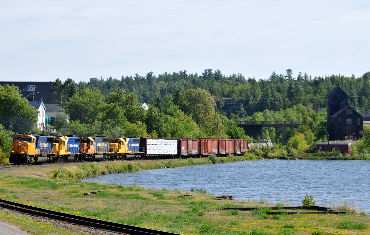 Ontario Northland train 214-09 (Engelhart, ON - North Bay, ON) passing through the town of Cobalt behind ONT 2104 - ONT 1809 - ONT 1735 - ONT 1733 and 57 cars