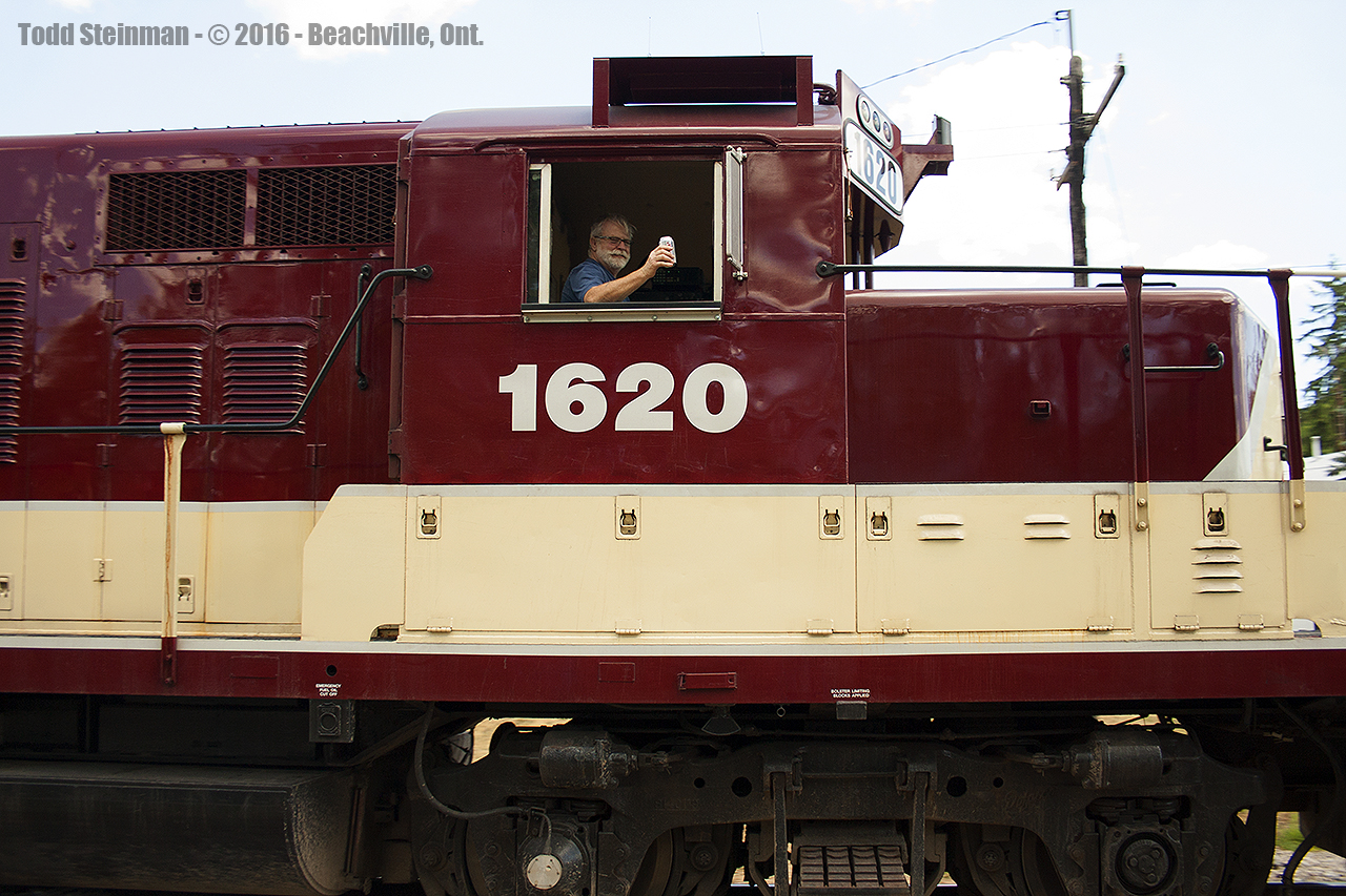 Finally, after a full day of railfanning, the engineer of OSR 162 gives us a 'cheers' for a job well done chasing his train through the country side, as it races through Beachville.