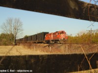 My 'oldies' again - When the same thing happens every single day, you sometimes try to  be a little different.. or well, this is my attempt at being a little different with the frame train, in the country using the scenery to my advantage. Every day, at about 0800 the frame train, with auto frames from St. Thomas for Oshawa would roll east on the Galt sub near Galt/Guelph Jct and it usually had the same pair of 60 MPH rated gp9's for months at a time. Mundane? Yes, but boring? No. I knew the geeps on this train , at speed, were special. It sounded special. Heck, the sweet morning light looked special, if you knew how to take advantage of it. Trust me, back then, I really didn't.. i was just shooting... I made so many mistakes. This is one of the few photos of this train that turned out :)<br><br>Photo notes: 50mm f/1.8, Nikon D70. This location is all grown in now.. at least for this angle.
