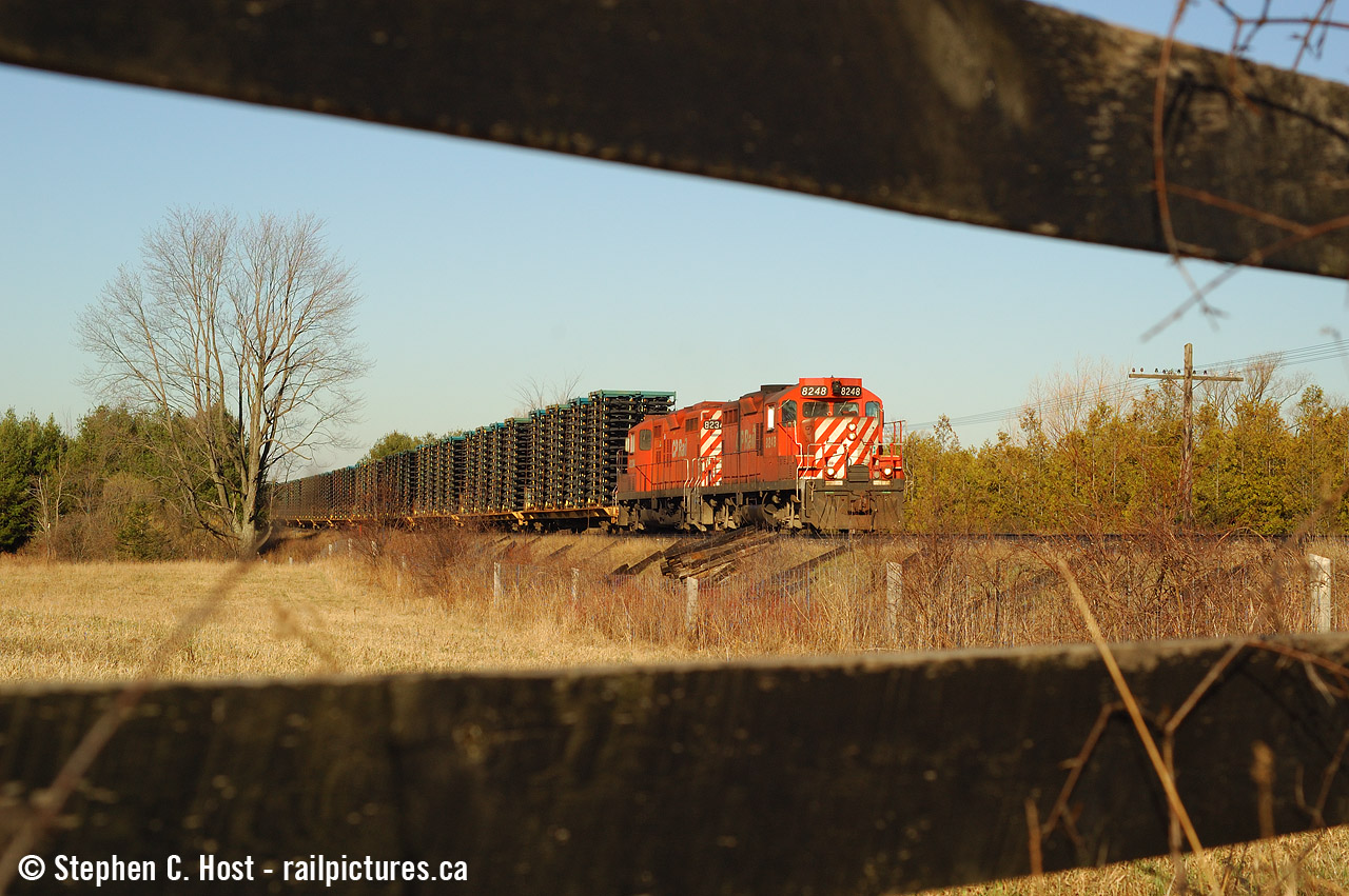 My 'oldies' again - When the same thing happens every single day, you sometimes try to  be a little different.. or well, this is my attempt at being a little different with the frame train, in the country using the scenery to my advantage. Every day, at about 0800 the frame train, with auto frames from St. Thomas for Oshawa would roll east on the Galt sub near Galt/Guelph Jct and it usually had the same pair of 60 MPH rated gp9's for months at a time. Mundane? Yes, but boring? No. I knew the geeps on this train , at speed, were special. It sounded special. Heck, the sweet morning light looked special, if you knew how to take advantage of it. Trust me, back then, I really didn't.. i was just shooting... I made so many mistakes. This is one of the few photos of this train that turned out :)Photo notes: 50mm f/1.8, Nikon D70. This location is all grown in now.. at least for this angle.