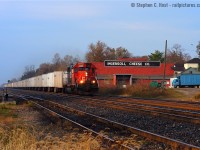 More of <i>my</i> oldies: When the cheese factory was still a cheese factory, and when I frowned upon single unit wonders, CN train 144 passes by Ingersoll at 0857 on a beauty October morning. I do not frown upon this photo anymore. Photo notes: one of my few photos taken with the Nikon D100, Nikkor 50mm f/1.8 at f/6.3 1/1250 ISO 200. I can't believe how primitive this 6 megapixel digital SLR camera was, and still is.. I used it for a week or two while my D70 was in the shop. All photos from this camera MUST be edited, nothing really comes out 'ready to go' without significant in-camera fiddling (curves, etc). How times have changed. OS notes: Four of the eight trains I shot on this day had SD40-2 leaders. Three more had SD75i's  and only one GE. Today, you'd be hard pressed for a single EMD leader (except Locals - how times have changed, part deux)