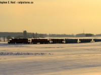 The hills of Sebringville glow a mighty orange in the setting winter sun while GEXR's extra 581 is nearly back at Stafford after a long day of plowing westward and hauling salt eastward. <br><br> A note to you young photographers, some advice: often the best lighting is directly opposite of what you think it is. So turn around and have a look :) As seen above.