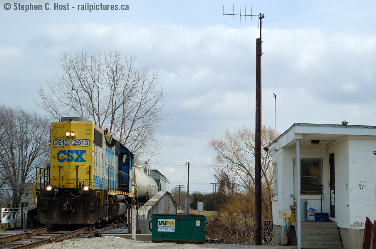 1225 James St, Wallaceburg. While many photographers focused on the bridge with the C&O Markings (Still there to this very day) I took a couple opportunities to record the north side of the bridge from James St. The cinder block building at right is the Wallaceburg RTC office - the smallest dispatching office in the CSX network. In 1996 CSX closed the St. Thomas division office and moved the RTC's to 1225 James St. But it was always the Bridgetender's building, and until 2013 a Bridgetender would have to come down from Sarnia to line the bridge when a train operated, as the RTC's did not have this in their collective agreements hence did not operate the swing bridge. (Note: The Bridgetender would use A mechanism inside the building, akin to a large safe with dials  to operate the bridge).
RTC's were on duty 24 hours a day, 7 days a week, and when this photo was taken only 2-3 trains a week operated into the OCS requiring a clearance. Prior to 2006 the usual number was about 4 to 6 movements a day, and in 1996 probably up to 8 to 10 with the majority being on the Chatham-Fargo segment of the CSX 

The RTC's radio tower is clearly seen at centre, and D724 is crossing the swing bridge at left. The RTC office was abolished at the end of October 2013 and by this time CSX had already reduced it from 24/7 to running on days the trains were scheduled to run.
Links to RTC recordings below!
Clearance to near Chatham
Clearance from Chatham to Blenheim
Another clearance July 15 2005