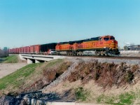 So that is how they do it. In order that the bridge be ready for the building of the Red Hill Valley Parkway in Hamilton, the new railroad bridge is built in its entirety, then the excavation is filled in again. Never knew that. Must be a reason why it is not left mostly open. After all, in order to put down the road they have to dig again.....Anyway, a few years before the roadway down the hill in Hamilton was opened, I shot this image of Buffalo-bound  #328 with BNSF 4813 and 5491 crossing the "bridge over nothing" before going to work my afternoon shift that day. A the time I was thinking the overall scene might be more of history than the BNSF units would eventually be along here ......