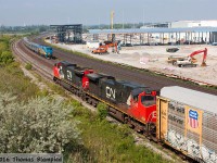 A nice meet and a nice excuse to talk about the continuing construction on GO Transit's new east maintenance facility. Firstly, this shot wraps up an unusually busy morning in the Whitby/Oshawa area, which saw two westbound freights working Oshawa Yard simultaneously (one on the main, and this one on the yard lead). As CN 2193 and 2555 prepare to depart with an unknown train (I suspect it is either 369 or 373), VIA 918 rolls past with train 64 and an all-Budd consist. In the background, construction of more sheds has begun and is beginning to obstruct the view from the Hopkins Street bridge. To the east, work continues on more structures. Currently, Hopkins is reduced to one lane with deep trenches being dug in the road. While the days of this location are undoubtedly numbered, there is still no sign of when the road will close.