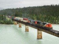 CN C40-8s 2127 and 2105 lead train Q102 across the Athabasca River between Entrance and Solomon on CN's Edson Subdivision. You won't find me taking pictures in this kind of weather very often, but I figured I'd make the effort for this nice pair of junkers on a hot stack train!