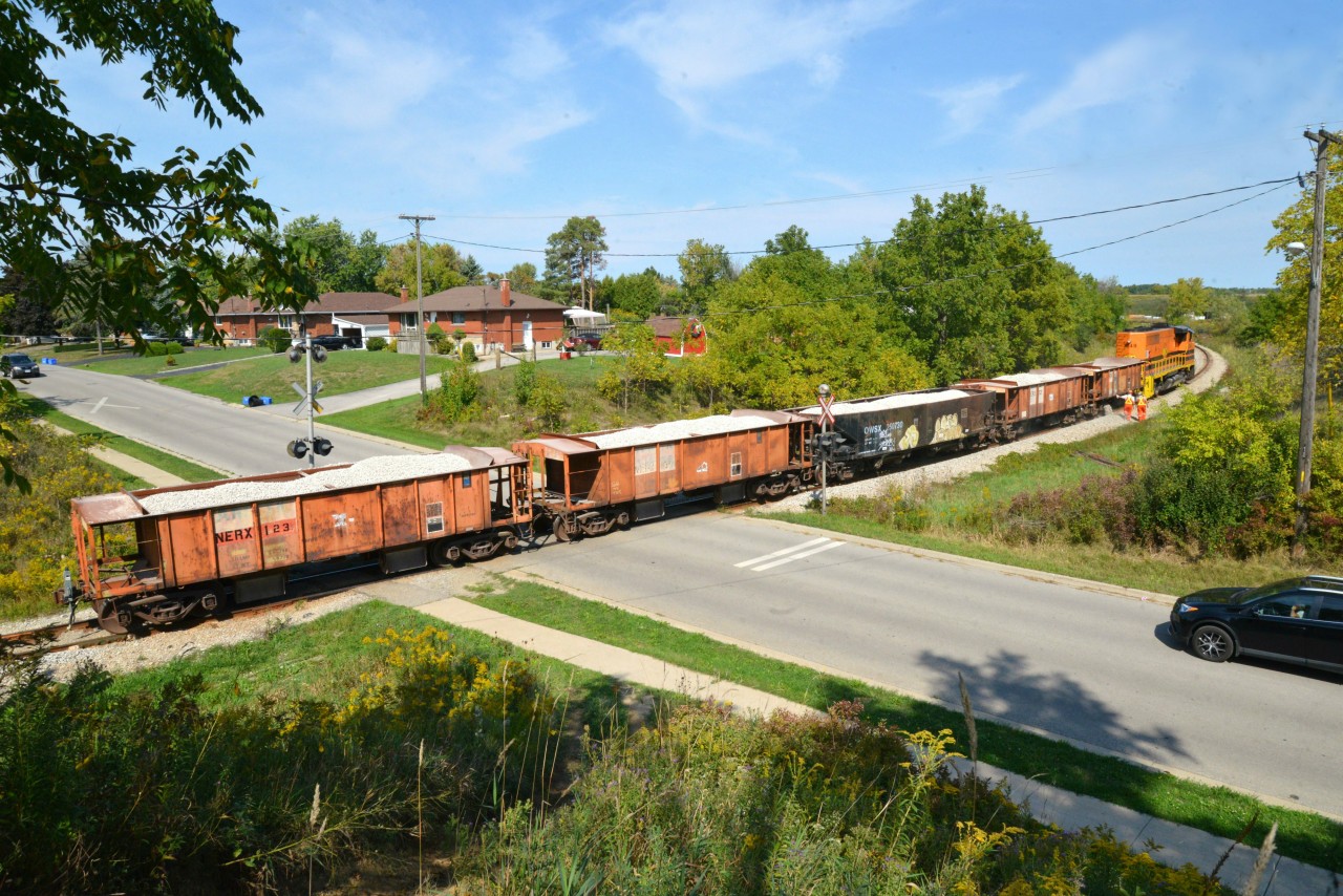 RLHH 3049 is on the point again this day powering the regular five car ballast train and rounding the curve (track also serves as the west leg of the Caledonia wye)on the main dropping ballast while working toward a westerly direction. This photo is a mate to #26251 crossing the Grand River albeit different loads and days.  The ballast team (two on each side) started this second drop of the day just north of Sutherland Street at the start of the leg and are now seen clearing Orkney Street, Caledonia.  During this 2-week ballast venture, RLHH 3049 can expect to be called for double duty and harnessed when needed on SOR's daily nocturnal freight.  In fact, I hear the whistle from my open window for RLHH 597 blowing for King Street, Hagersville as I sign off 9:50 p.m.