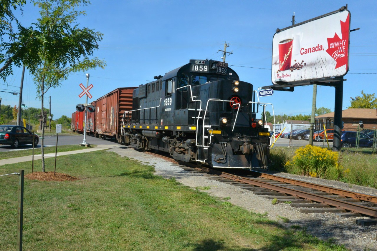 What does a School Crossing Guard do on a ‘PD’ or Professional Activity Day?  If a raifan, seize the opportunity to take a trackside ‘Photo Day’ of course! While chasing the Trillium Railway’s Friday solo powered freight northbound from Dain City on the Canal and Thorold Spurs to Merritton, I observed several intriguing trackage configerations, couple of neat switching moves and an abundance of Seaway traffic on the Welland Canal.  The most time consuming and complex move of the day goes to the tick-tack-toe 4-point switching maneuver required to cross the double tracked Grimsby Sub both northbound from Thorold to Merriton & St Catharines and then vice-versa when southbound back home to Dain City.  The “PD’ or photo of day goes to Ontario’s Trillium 1859 and four clean box cars parading diagonally and boldly across Merritt & Seymour to pose briefly with Tim Horton’s impressive Canadian, Maple-leaf billboard.  I can’t think of a more fitting image for a proud Canuk coffee loving railfan from Ontario enjoying a sunny, trackside ‘PD’ holiday? 

KUDOS to Trillium Railway Co. LTD., a short line railway founded in 1997, currently operate the Port Colborne Harbour Railway (PCHR) serving 19 customers on its 50KM long network located in the Niagara Region providing interchange with both CN and CPR.