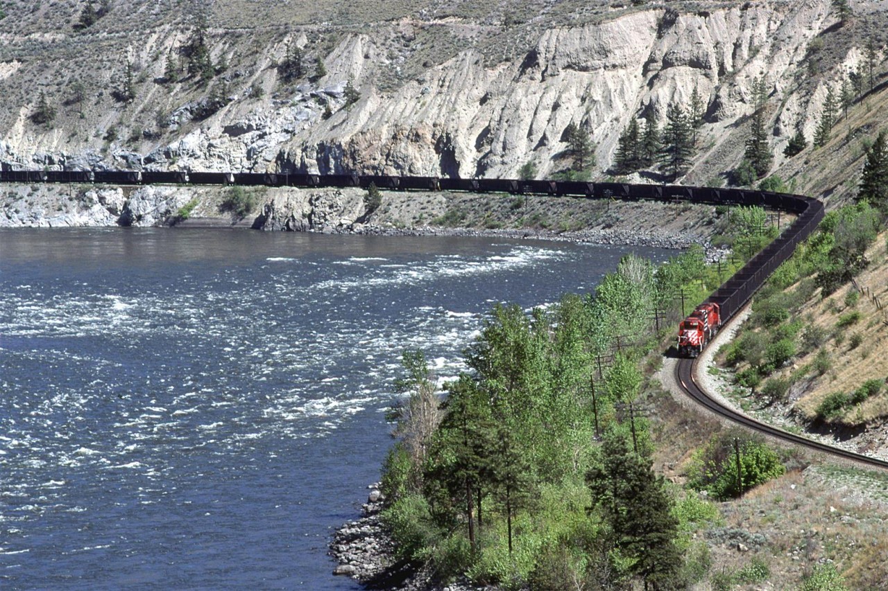 A loaded coal train, bound for Roberts Bank outside Vancouver swings through a big curve along the Thompson River. This is a few miles east of Spences Bridge.
Those hoppers don't look that full, though.