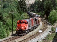 My notes say that this is at Martinson, but I do not know for certain. It might be at Boston Bar.
Anyway, this is a loaded grain train as it approaches Boston Bar. The units look like they were in aggregate service recently.