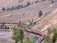 A CP grain train headed for Vancouver is approaching Spences Bridge. It is strange to have only two locomotives up front, but two mid-train units can also be seen.