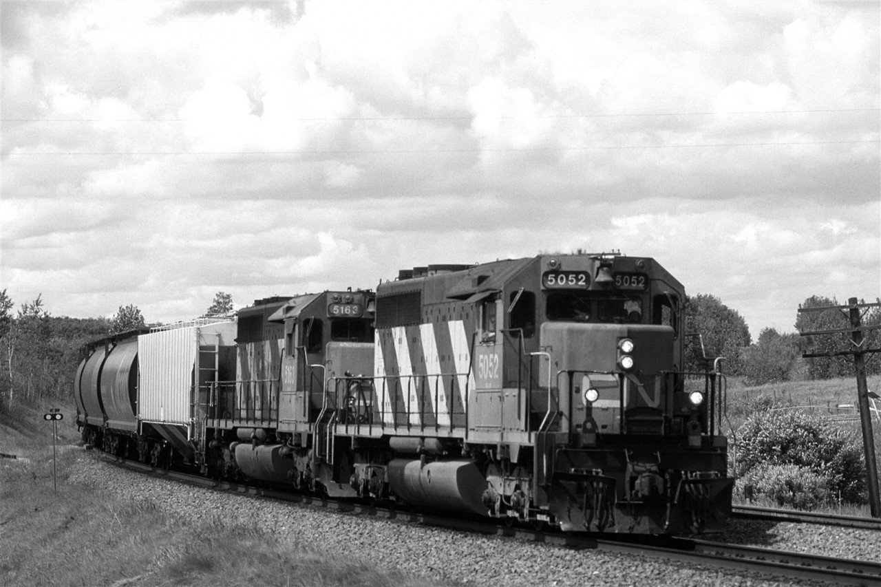 An eastbound empty grain train rounds the curves of Carvell