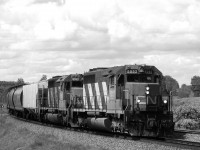 An eastbound empty grain train rounds the curves of Carvell