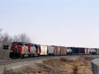 Not looking much like a high priority train this #219 is approaching 50 St (then, a level crossing) in eastern Edmonton. That double tracking was put in about a year ago.