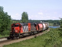 This is a westbound grain train on the south track through the two big bends at Carvel. Mink Lake can be seen at right.