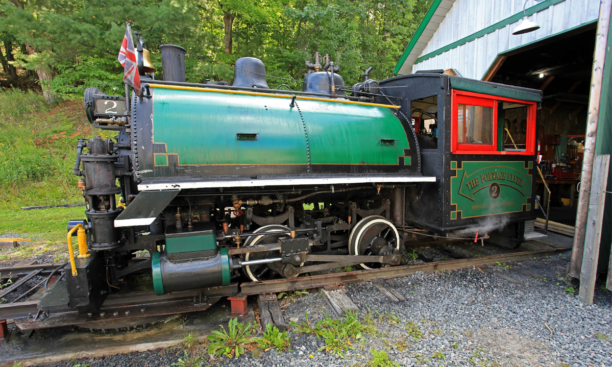 Some days you're better off staying in bed, and this was one of mine. It actually started the previous day, internal problems with the locomotive affected the drivability so negatively that I was barely able to limp home on the second-last run and get the old girl in the shed and take out the diesel to do the final run. To make a long story short, we thought we'd figured an easy fix and tried it out the next morning, but soon discovered it was worse than ever. Didn't even make it out of the yard to back up and hook onto the coaches. Had another engineer in the diesel start to push us back into the shed, but traversing the turntable the link-and-pin coupler caused a bit of lateral force, which caused the bit of slop in the turntable lock to allow a bit of misalignment. A rear flange caught the end of the static rail and rode up on it. The rails were still wet after a heavy morning fog and the diesel couldn't stop in time and this is what resulted. The locomotive has since been re-railed and put to bed, and we think we've narrowed down the internal fault to a hole in the pipe from the steam dome to the turret. Unfortunately we probably won't be able to get this fixed before the "official" end of Steam Season this coming Saturday.