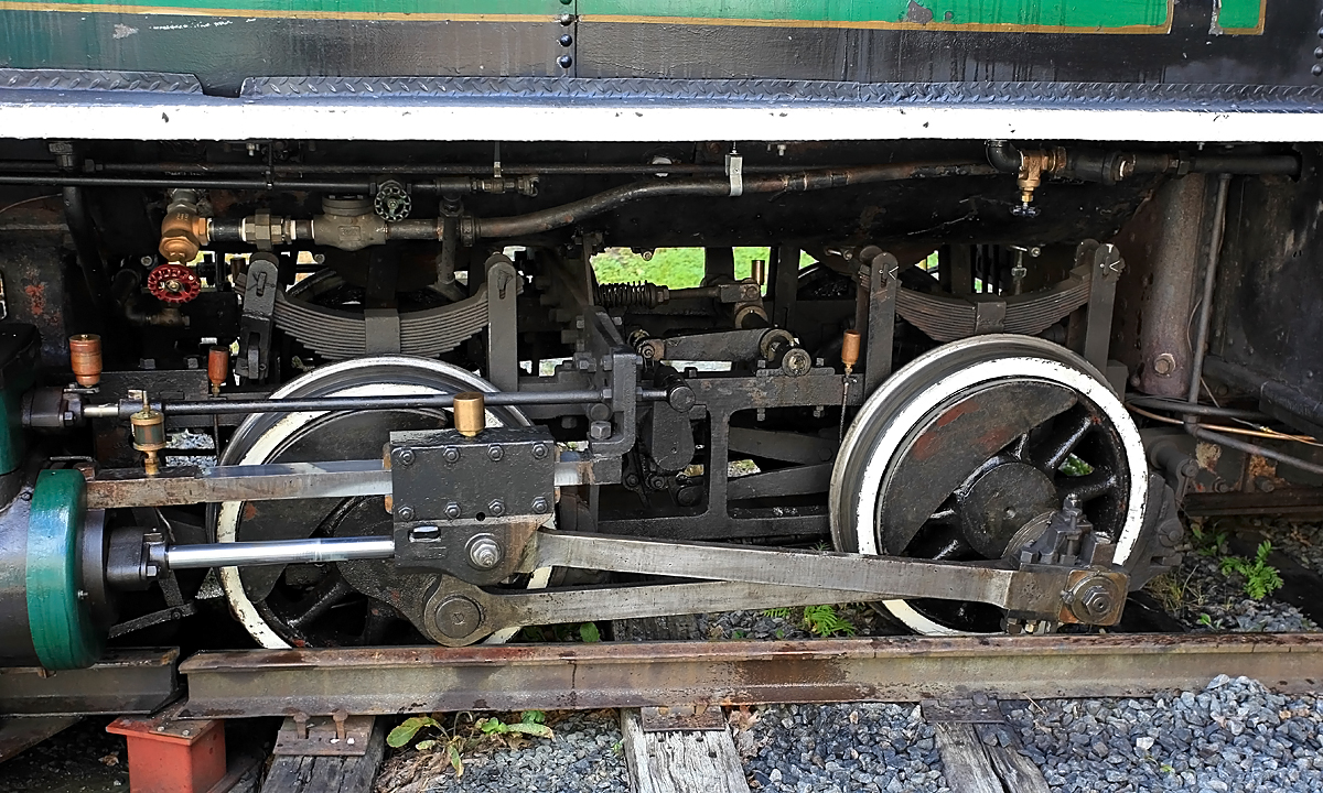 Some days you're better off staying in bed, and this was one of mine. It actually started the previous day, internal problems with the locomotive affected the drivability so negatively that I was barely able to limp home on the second-last run and get the old girl in the shed and take out the diesel to do the final run. To make a long story short, we thought we'd figured an easy fix and tried it out the next morning, but soon discovered it was worse than ever. Didn't even make it out of the yard to back up and hook onto the coaches. Had another engineer in the diesel start to push us back into the shed, but traversing the turntable the link-and-pin coupler caused a bit of lateral force, which caused the bit of slop in the turntable lock to allow a bit of misalignment. A rear flange caught the end of the static rail and rode up on it. The rails were still wet after a heavy morning fog and the diesel couldn't stop in time and this is what resulted. The locomotive has since been re-railed and put to bed, and we think we've narrowed down the internal fault to a hole in the pipe from the steam dome to the turret. Unfortunately we probably won't be able to get this fixed before the "official" end of Steam Season this coming Saturday.