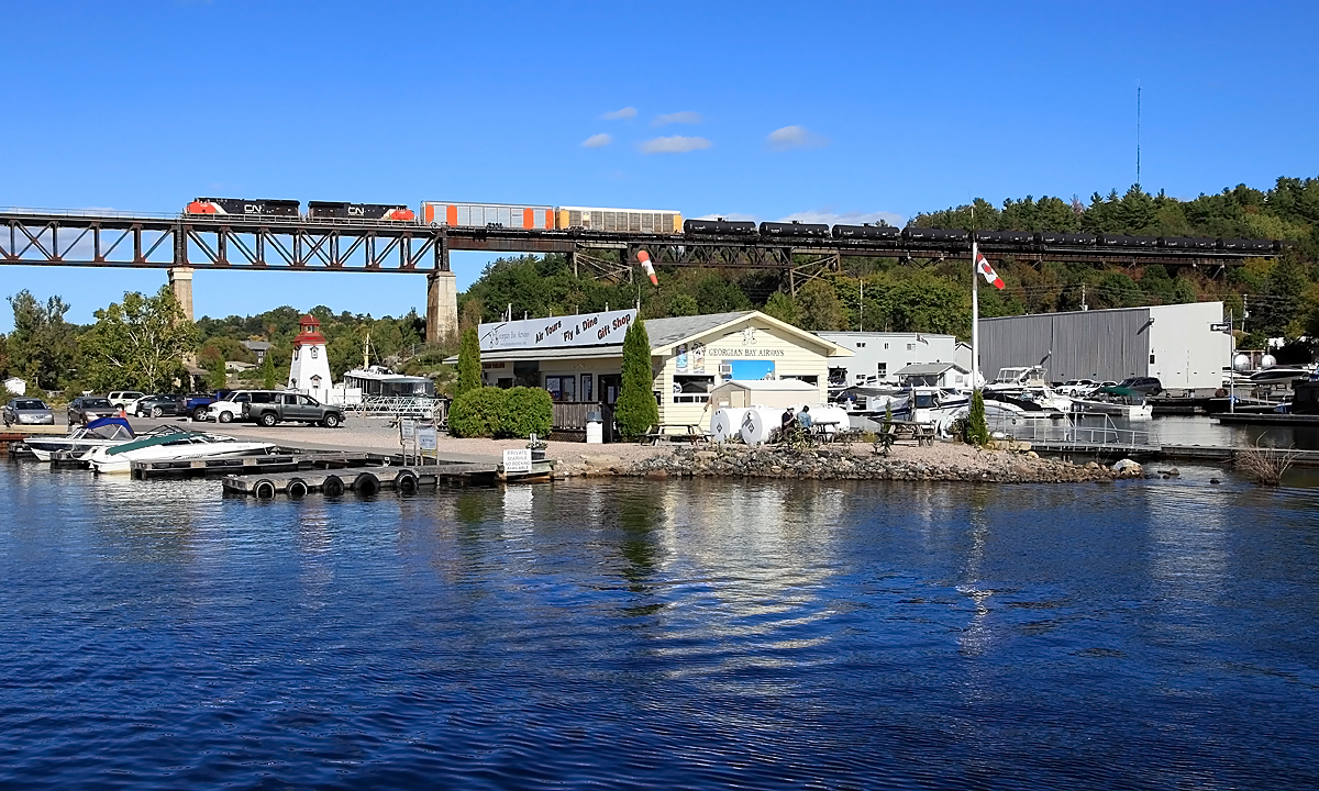 Attended a wedding in Parry Sound this afternoon, got there early to see if I could catch anything going over the harbor on the CP trestle. Missed the first one by a stoplight, but caught this one about 1/2 hour later, a long CN manifest with about 1/2 mile of oilcans bringing up the rear.