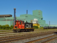 <b>In the heart of Steeltown!</b>  History rides the rails at the CN Steel Center in industrial Hamilton, where CN SW1200 7304 switches cars around the yard in front of Dofasco Central Shipping.<br><br>To my knowledge, this was one of two SW1200's on the CN roster, however, only CN 7311 (assigned to the steel transfer facility in Mac Yard) is on the roster.  Can anyone clarify if the 7304 is owned by CN?