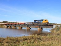 ONT 308 crosses the Frederick House River with 2104 leading 27 cars.  The covered gondolas are full of copper and zinc concentrate from the Kidd Mine.