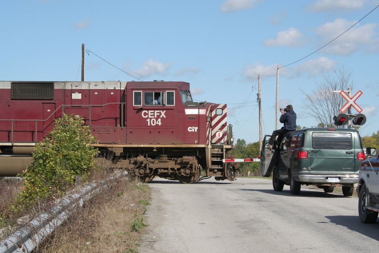 Somewhere near Welland, ON in the Niagara Region. CP led by CEFX 104 towards the border. Railfan on top his vehicle. I don't know...