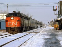 VIA train #75 arrives at Chatham station, behind CN-painted FPA4 6772 (still with its CN noodle on the nose, and not yet repainted for VIA). In the distance is the crossing with the C&O Sub 2, and the large steel bridge crossing McGregor Creek.