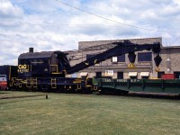 Cheapeake and Ohio 150-ton steam-powered wrecking crane C&O 940002 is pictured with idler flatcar 940058 and tender 940352 by the C&O's roundhouse in St Thomas ON, in June 1985. It was originally built by Industrial Works of Bay City, MI as Pere Marquette DK-5 (DK standing for "derrick") in 1927. It became C&O 940002, and later served under CSX (not relettered from C&O) until being retired and scrapped.