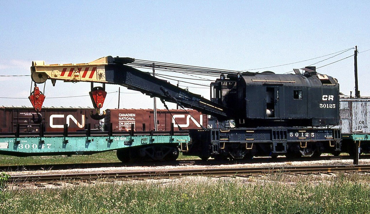 Conrail 150-ton wrecking crane 50125, formerly Penn Central and long based on the CASO at St. Thomas, is shown with its idler cars (still bearing PC logos and paint) on CN at London on June 5th 1987.

It was later sent for scrap to CN's London Reclaimation Yard in 1991 (as shown in this Paul O'Shell photo: http://www.railpictures.ca/?attachment_id=5865)