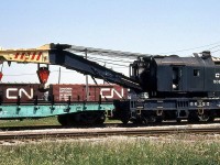 Conrail 150-ton wrecking crane 50125, formerly Penn Central and long based on the CASO at St. Thomas, is shown with its idler cars (still bearing PC logos and paint) on CN at London on June 5th 1987.
<br><br>
It was later sent for scrap to CN's London Reclaimation Yard in 1991 (as shown in this Paul O'Shell photo: <a href=http://www.railpictures.ca/?attachment_id=5865><b>http://www.railpictures.ca/?attachment_id=5865</b></a>)
