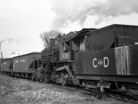 Canada & Dominion Sugar 7456 (a former Canadian National 0-6-0, nee-GTR, that was first leased by C&D and later purchased) switches hoppers and drop-bottom gondolas loaded with locally-grown sugar beets into the Chatham Ontario plant in November 1960. Next year the harvest would be switched with a Wabash diesel locomotive, and would be the last year before the plant was torn down.<br><br>The Canada and Dominion Sugar Company was a result of the 1930 merger between sugar producers Canadian Sugar Refining Company (of Montreal) and The Dominion Sugar Company of Chatham ON. By this time, the company had just changed names in 1959 to Redpath Sugars Ltd.<br><br>The Chatham plant was built by the Dominion Sugar Company in 1915 and located north of Merritt Ave and King St. West just south of the Thames River, served by rail from a spur off CP's Windsor Sub. The opening of the new Redpath Toronto plant on the harbourfront of Lake Ontario (with access to the new St. Lawrence Seaway) in 1959 resulted in the closure of the Chatham plant in short order. The end of the use of sugar beets in Ontario plants would follow a few years later when the Wallaceburg plant was closed in 1968 (the Toronto plant used cane sugar).<br><br>7456 was saved from the scrapper in 1964 by the Ontario Government for inclusion in a proposed rail museum with other steamers (that never came about), and today is presently on display at the Heritage Village in Sidney, Michigan.