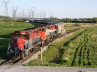 RLK 5005, RMPX 9431 and RLK 4057 quietly wait for the evening crew to take SOR 597's daily freight to Brantford and CN interchange.  This photo of SOR 597 and surrounding trackage was taken from Concession 8 (south edge of the Garnet Yard)looking southward. The still standing trackside switch cabinet in the distance (mile 4.4) marks the crossing site and diamond of the former CN Cayuga Subdivision and the Hagersville Subdivision. The connecting track still exists plus part of the Cayuga Subdivision to the west (almost to Regional Road 55. SOR continue to utilize this trackage for tank car storage.  The n/w connecting track has been disconnected at the westerly point. Fast forward to this day and same location ... now its G&W livery / colours, numerous wind turbines and drone photography.