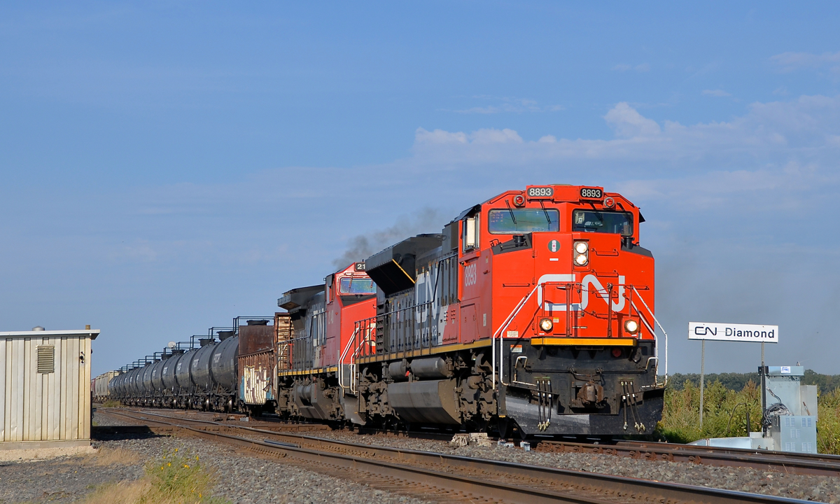 Over the diamond at CN Diamond CN 8893 & CN 2140 lead CN 318 over the diamond at CN Diamond. CN Diamond is at MP 14.3 of CN's very busy Rivers Sub where it crosses CP's not so busy Glenboro Sub a bit west of Winnipeg.