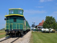 <b>Caboose on the rear.</b> The Prairie Dog Central's 11 AM departure is getting ready to leave the station at Inkster Junction with their ex-CP caboose bringing up the rear. Steam is seen up front from 4-4-0 PDC 3 (ex-CP 22).