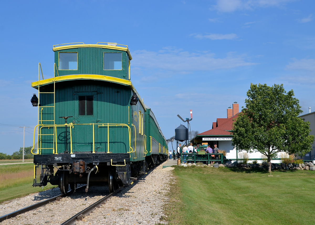 Caboose on the rear. The Prairie Dog Central's 11 AM departure is getting ready to leave the station at Inkster Junction with their ex-CP caboose bringing up the rear. Steam is seen up front from 4-4-0 PDC 3 (ex-CP 22).