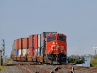 <b>Crossing over at CN Diamond.</b> CN 2938 brings up the rear of CN 101 as it crosses from the north to south track at CN Diamond. Further ahead at right the train can be seen curving as it heads westwards.