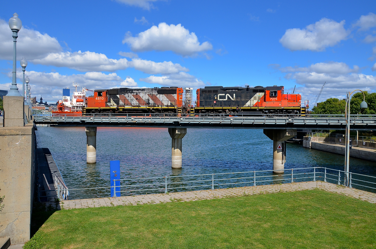 CN 4810 & CN 7075 are heading light into the Port of Montreal to pick up some cars as they cross the eastern end of the Lachine Canal. At left can be seen the superstructure of the bulk carrier Venture, which has been in the port all summer long.