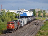 <b>A pair of Dash8's.</b> CN 2440 & CN 2181 lead CN 318 into Symington Yard in Winnipeg as the train passes Beach Jct.