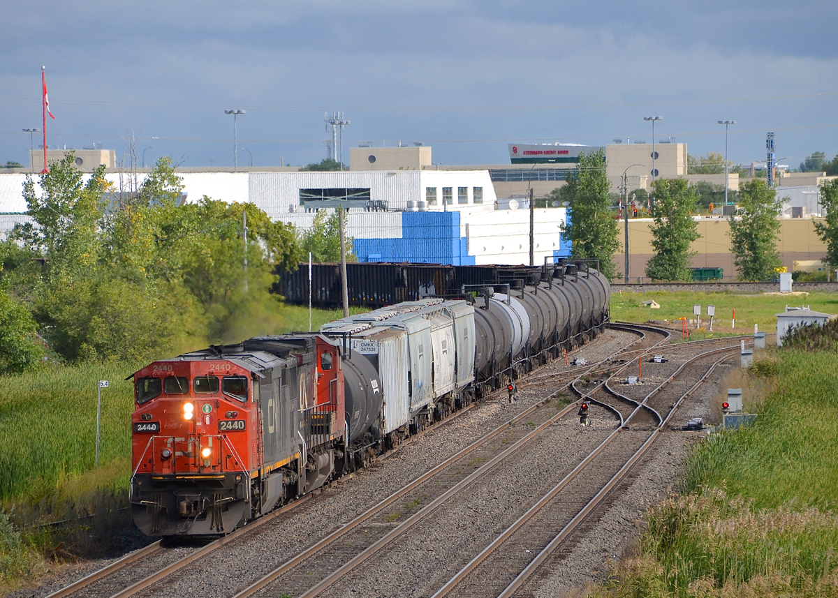 A pair of Dash8's. CN 2440 & CN 2181 lead CN 318 into Symington Yard in Winnipeg as the train passes Beach Jct.