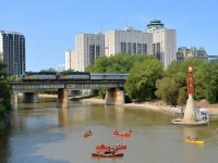 VIA 1 is seen crossing the Assiniboine River after leaving Winnipeg Union Station a bit over 35 minutes late (1223 vs scheduled departure time of 1145). Power is VIA 6431 & VIA 6451.