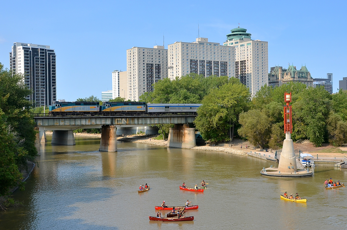 VIA 1 is seen crossing the Assiniboine River after leaving Winnipeg Union Station a bit over 35 minutes late (1223 vs scheduled departure time of 1145). Power is VIA 6431 & VIA 6451.