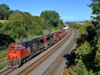 <b>Older power.</b> CN 401 has a pair of ex-ATSF Dash8-40CW's followed by a trio of geeps (CN 2180, CN 2152, CN 9450, CN 4140 & CN 9486) as it heads through Montreal West on a gorgeous fall afternoon. No new power here, the combined age of these 5 units is 182 years old!