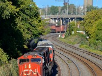 <b>Back on the transfer track.</b> Between Turcot Ouest and Ballantyne CN's Montreal sub is four tracks wide. The northernmost track is named the transfer track and it goes back and forth between being used for car storage and being used as an active track. After not being used since around spring 2015 (with well cars stored on it most of that time) it is now in service again. Here CN 527 heads west towards Taschereau Yard with SD75I CN 5708 leading.