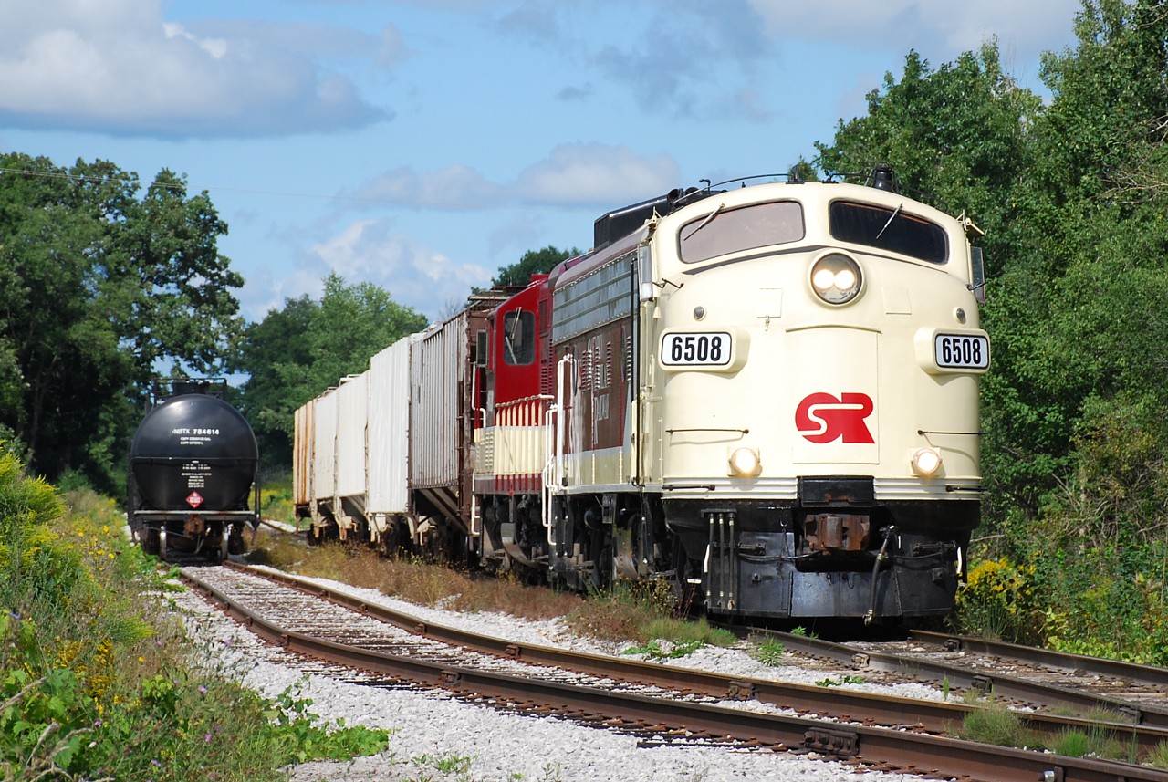 OSRX 6508 and 1620 have left most of their train east of the connection track to CN, and are heading west with five covered hoppers that they lifted in Beachville and will soon drop them at the customer in Putnam.
