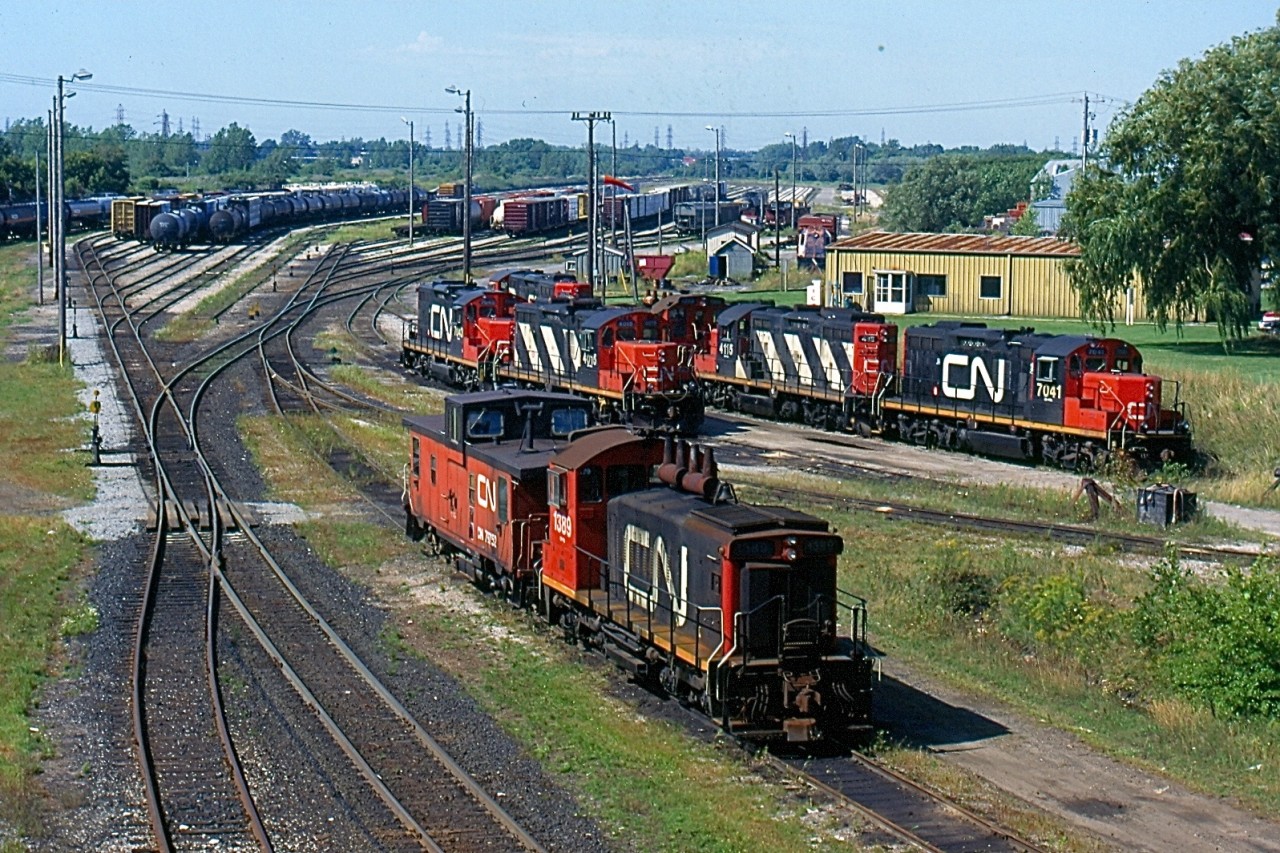 Back in 1997 CN's yard in Niagara Falls was still a fairly busy place, with a number of locals serving the Niagara region assigned there. Power at the time was typically GP9RM's and SW1200's, and vans were still common on most local jobs. Today Trillium RR has taken over most of CN's local assignments in the region. The yard here has been abandoned like the one at a Fort Erie. Port Robinson is now CN's main yard in the region and only a couple of four axle units are kept ther for any remaining customers directly served by CN.