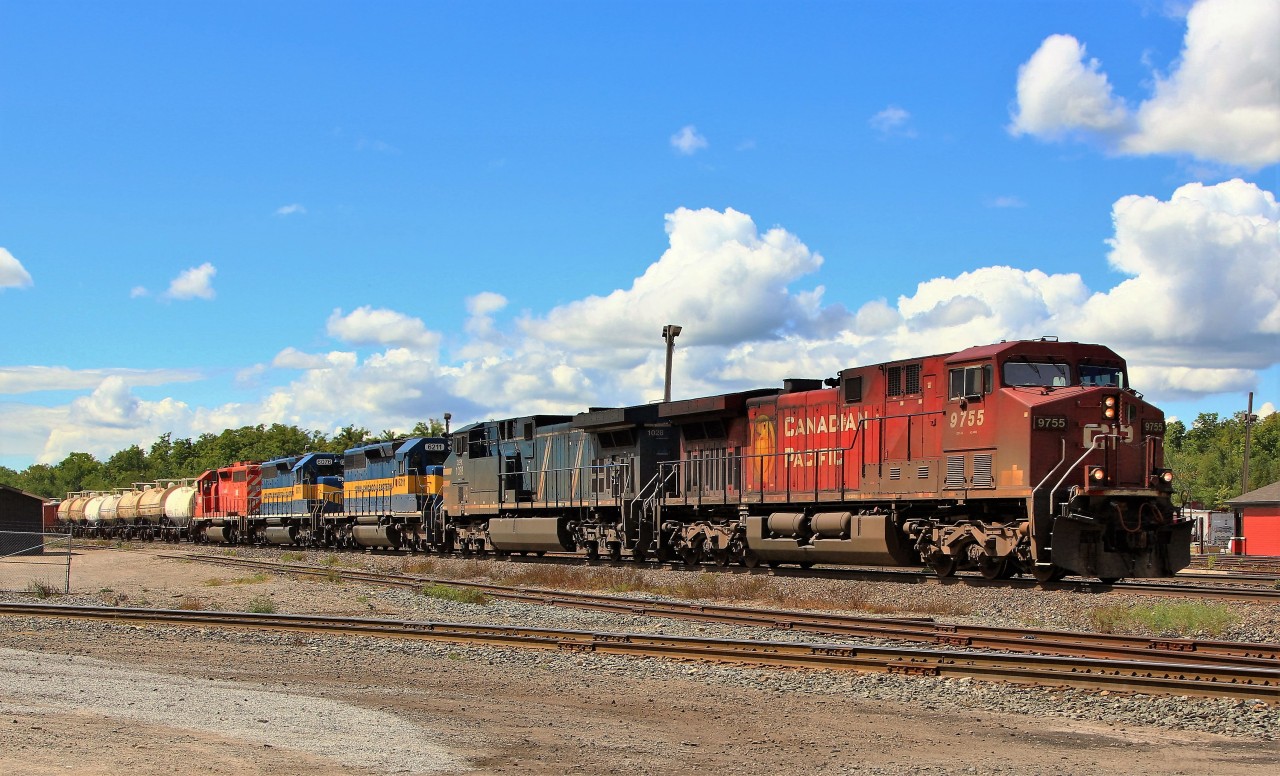 Here we find a trio of SD40's making their way to Toronto on Eastbound CP 242 through Guelph Junction. Leading the 6500+ train is CP 9755 with CEFX 1028 for power. Taking the ride are ICE 6211 (SD40-2), DME 6076 (SD40-3), still in nice blue and yellow, and DME 6092 (SD40-3) in faded CP red.
